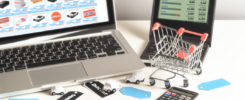 alt_text: Organized workspace with a laptop on shopping sites, shopping cart, discount tags, and calculator.