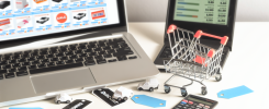 alt_text: Organized workspace with a laptop on shopping sites, shopping cart, discount tags, and calculator.
